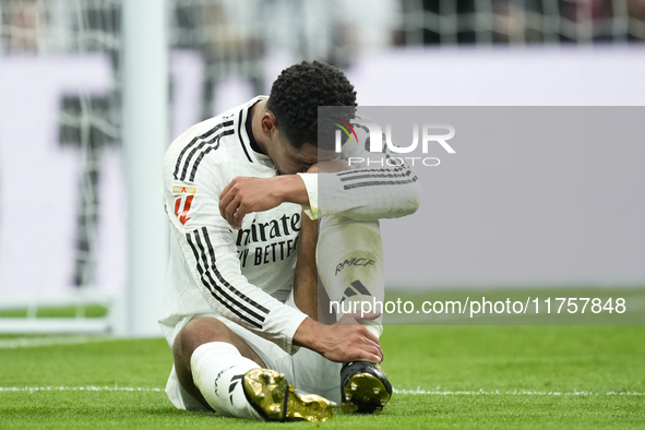 Jude Bellingham central midfield of Real Madrid and England lies injured on the pitch during the La Liga match between Real Madrid CF and CA...