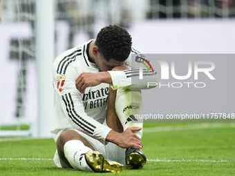 Jude Bellingham central midfield of Real Madrid and England lies injured on the pitch during the La Liga match between Real Madrid CF and CA...