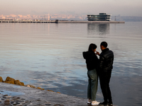 A couple stands on Caspian Sea Boulevard in Baku, Azerbaijan on November 9, 2024. (