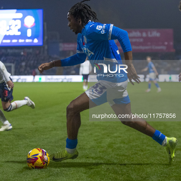 Tayo Adaramola, number 33 of Stockport County F.C., is in possession of the ball during the Sky Bet League 1 match between Stockport County...