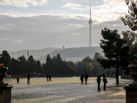 People walk on Caspian Sea Boulevard in Baku, Azerbaijan on November 9, 2024. (