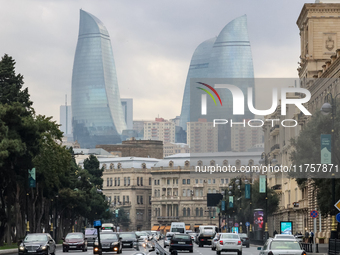 Flame towers are seen from a distance with older part of city in front in Baku, Azerbaijan on November 9, 2024. (