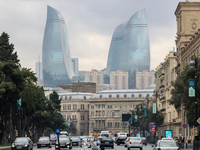 Flame towers are seen from a distance with older part of city in front in Baku, Azerbaijan on November 9, 2024. (