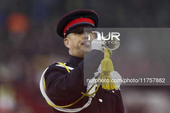 A member of the military plays the bugle in honor of Remembrance during the Premier League match between Brentford and Bournemouth at the Gt...