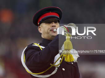 A member of the military plays the bugle in honor of Remembrance during the Premier League match between Brentford and Bournemouth at the Gt...