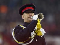 A member of the military plays the bugle in honor of Remembrance during the Premier League match between Brentford and Bournemouth at the Gt...