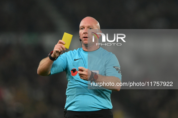 Referee Simon Hooper produces a yellow card during the Sky Bet Championship match between Derby County and Plymouth Argyle at Pride Park in...