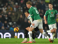 Jerry Yates of Derby County shields the ball from Kornel Szucs of Plymouth Argyle during the Sky Bet Championship match between Derby County...