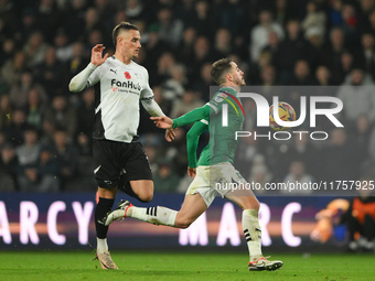 Julio Pleguezuelo of Plymouth Argyle is under pressure from Jerry Yates of Derby County during the Sky Bet Championship match between Derby...