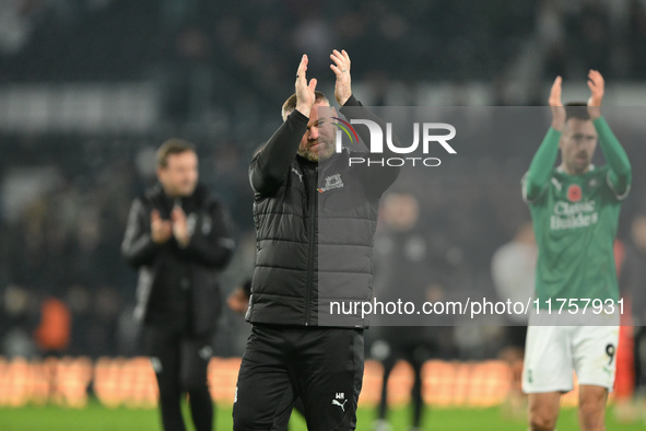 Wayne Rooney, manager of Plymouth Argyle, applauds his team's supporters during the Sky Bet Championship match between Derby County and Plym...