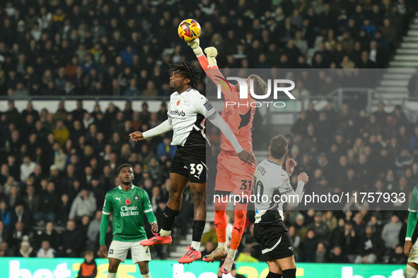 Daniel Grimshaw of Plymouth Argyle competes with Dajaune Brown of Derby County during the Sky Bet Championship match between Derby County an...