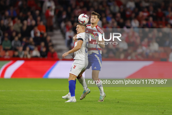 Miguel Rubio of Granada CF and Quintana of CD Eldense participate in the LaLiga Hypermotion match between Granada CF and CD Eldense at Nuevo...