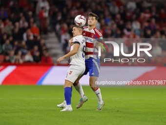 Miguel Rubio of Granada CF and Quintana of CD Eldense participate in the LaLiga Hypermotion match between Granada CF and CD Eldense at Nuevo...