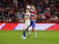 Miguel Rubio of Granada CF and Quintana of CD Eldense participate in the LaLiga Hypermotion match between Granada CF and CD Eldense at Nuevo...