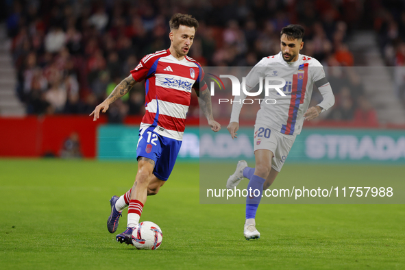 Ricard Sanchez of Granada CF and Ivan Chapela of CD Eldense participate in the LaLiga Hypermotion match between Granada CF and CD Eldense at...