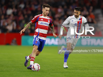 Ricard Sanchez of Granada CF and Ivan Chapela of CD Eldense participate in the LaLiga Hypermotion match between Granada CF and CD Eldense at...