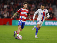 Ricard Sanchez of Granada CF and Ivan Chapela of CD Eldense participate in the LaLiga Hypermotion match between Granada CF and CD Eldense at...