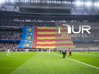 Fans display a huge flag of the Comunidad Valenciana in memory of the victims of the recent floods during the La Liga EA Sports 2024/25 foot...