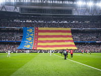 Fans display a huge flag of the Comunidad Valenciana in memory of the victims of the recent floods during the La Liga EA Sports 2024/25 foot...