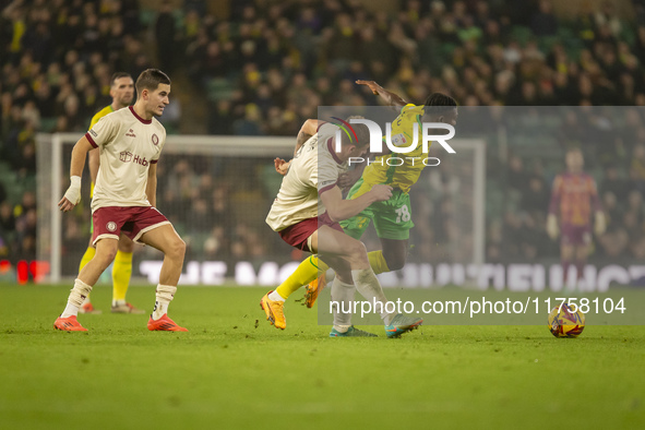 Forson Amankwah of Norwich City is tackled by Max Bird of Bristol City during the Sky Bet Championship match between Norwich City and Bristo...