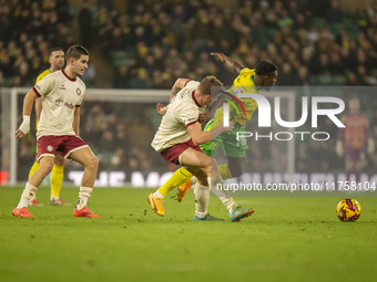 Forson Amankwah of Norwich City is tackled by Max Bird of Bristol City during the Sky Bet Championship match between Norwich City and Bristo...