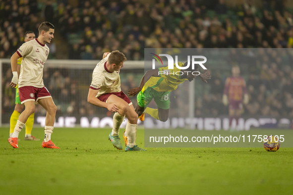 Forson Amankwah of Norwich City is tackled by Max Bird of Bristol City during the Sky Bet Championship match between Norwich City and Bristo...