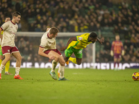 Forson Amankwah of Norwich City is tackled by Max Bird of Bristol City during the Sky Bet Championship match between Norwich City and Bristo...