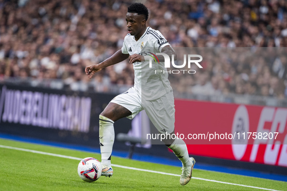 Vinicius Junior of Real Madrid CF is in action with the ball during the La Liga EA Sports 2024/25 football match between Real Madrid CF and...