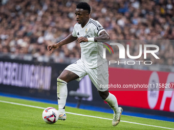 Vinicius Junior of Real Madrid CF is in action with the ball during the La Liga EA Sports 2024/25 football match between Real Madrid CF and...