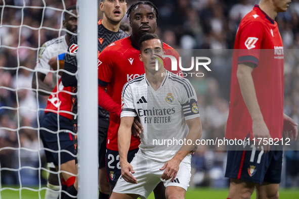 Lucas Vazquez of Real Madrid CF (right) fights for the position against Flavien Boyomo of CA Osasuna (left) during the La Liga EA Sports 202...