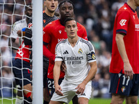 Lucas Vazquez of Real Madrid CF (right) fights for the position against Flavien Boyomo of CA Osasuna (left) during the La Liga EA Sports 202...