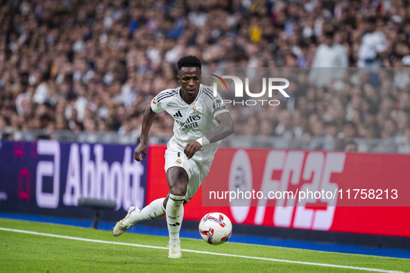 Vinicius Junior of Real Madrid CF is in action with the ball during the La Liga EA Sports 2024/25 football match between Real Madrid CF and...