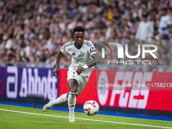 Vinicius Junior of Real Madrid CF is in action with the ball during the La Liga EA Sports 2024/25 football match between Real Madrid CF and...