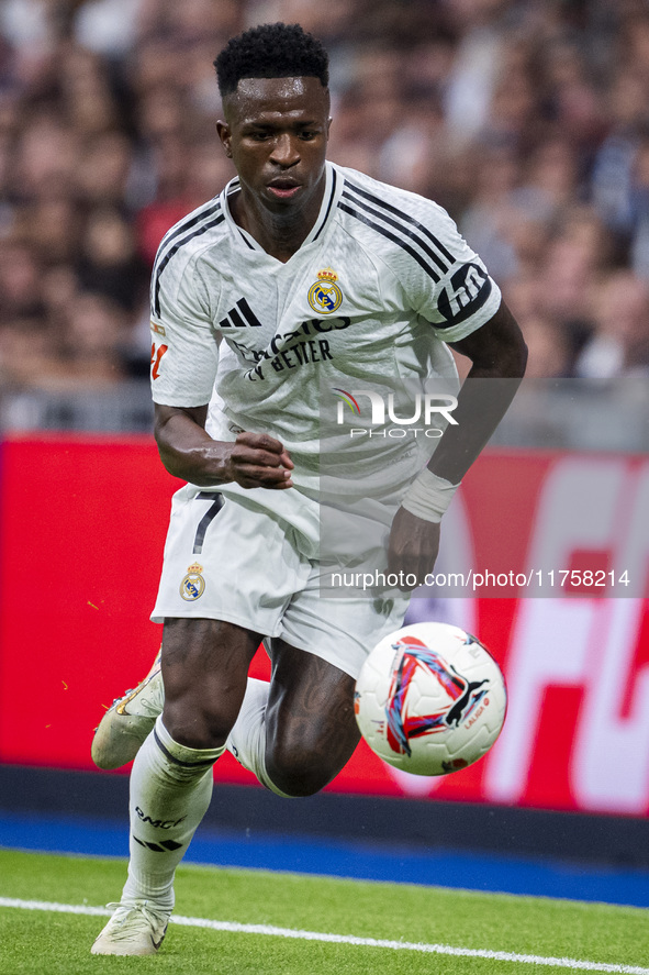 Vinicius Junior of Real Madrid CF is in action with the ball during the La Liga EA Sports 2024/25 football match between Real Madrid CF and...