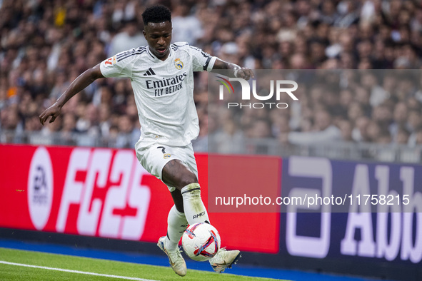 Vinicius Junior of Real Madrid CF is in action with the ball during the La Liga EA Sports 2024/25 football match between Real Madrid CF and...