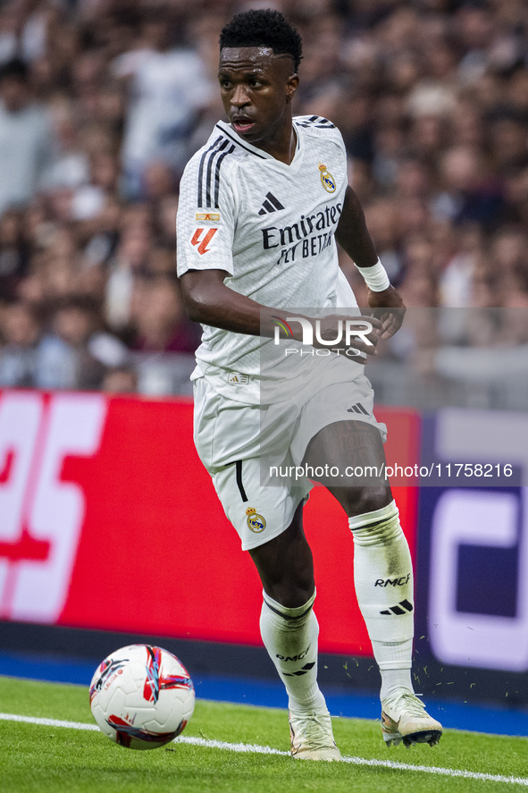 Vinicius Junior of Real Madrid CF is in action with the ball during the La Liga EA Sports 2024/25 football match between Real Madrid CF and...