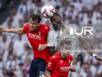 Antonio Rudiger of Real Madrid CF heads the ball between Ante Budimir and Aimar Oroz of CA Osasuna during the La Liga EA Sports 2024/25 foot...