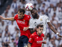 Antonio Rudiger of Real Madrid CF heads the ball between Ante Budimir and Aimar Oroz of CA Osasuna during the La Liga EA Sports 2024/25 foot...