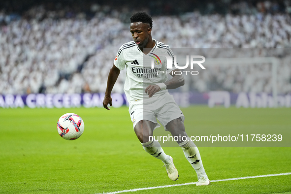 Vinicius Junior left winger of Real Madrid and Brazil controls the ball during the La Liga match between Real Madrid CF and CA Osasuna at Es...