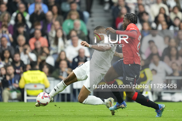 Kylian Mbappe centre-forward of Real Madrid and France shooting to goal front Enzo Boyomo centre-back of Osasuna and Cameroon during the La...