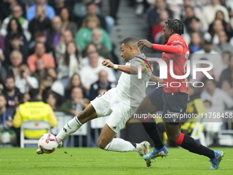 Kylian Mbappe centre-forward of Real Madrid and France shooting to goal front Enzo Boyomo centre-back of Osasuna and Cameroon during the La...