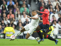 Kylian Mbappe centre-forward of Real Madrid and France shooting to goal front Enzo Boyomo centre-back of Osasuna and Cameroon during the La...