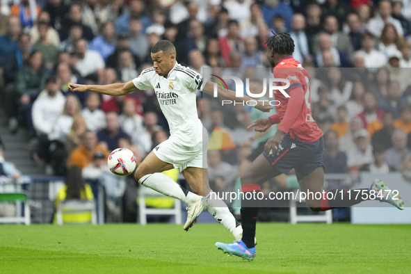 Kylian Mbappe centre-forward of Real Madrid and France and Enzo Boyomo centre-back of Osasuna and Cameroon during the La Liga match between...