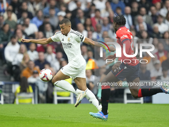 Kylian Mbappe centre-forward of Real Madrid and France and Enzo Boyomo centre-back of Osasuna and Cameroon during the La Liga match between...