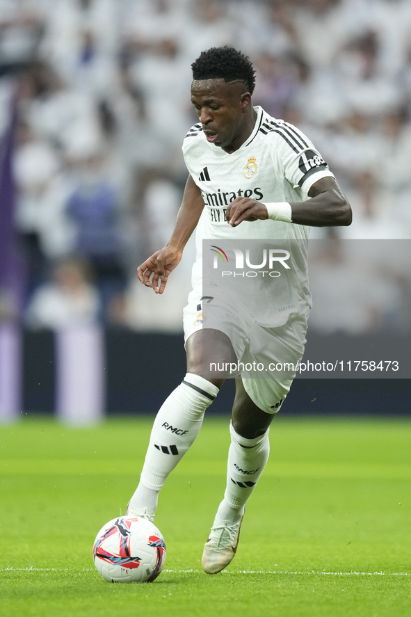 Vinicius Junior left winger of Real Madrid and Brazil in action during the La Liga match between Real Madrid CF and CA Osasuna at Estadio Sa...