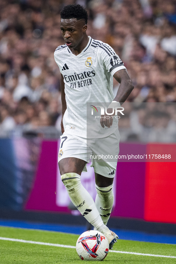 Vinicius Junior of Real Madrid CF is in action with the ball during the La Liga EA Sports 2024/25 football match between Real Madrid CF and...