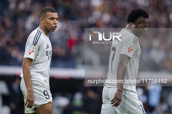 Kylian Mbappe of Real Madrid CF (left) talks to Vinicius Junior of Real Madrid CF (right) during the La Liga EA Sports 2024/25 football matc...