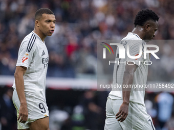 Kylian Mbappe of Real Madrid CF (left) talks to Vinicius Junior of Real Madrid CF (right) during the La Liga EA Sports 2024/25 football matc...