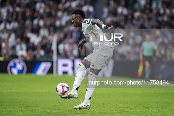 Vinicius Junior of Real Madrid CF is in action with the ball during the La Liga EA Sports 2024/25 football match between Real Madrid CF and...