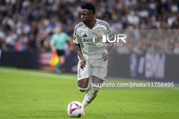 Vinicius Junior of Real Madrid CF is in action with the ball during the La Liga EA Sports 2024/25 football match between Real Madrid CF and...